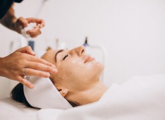 Cosmetologist applying product on woman’s face