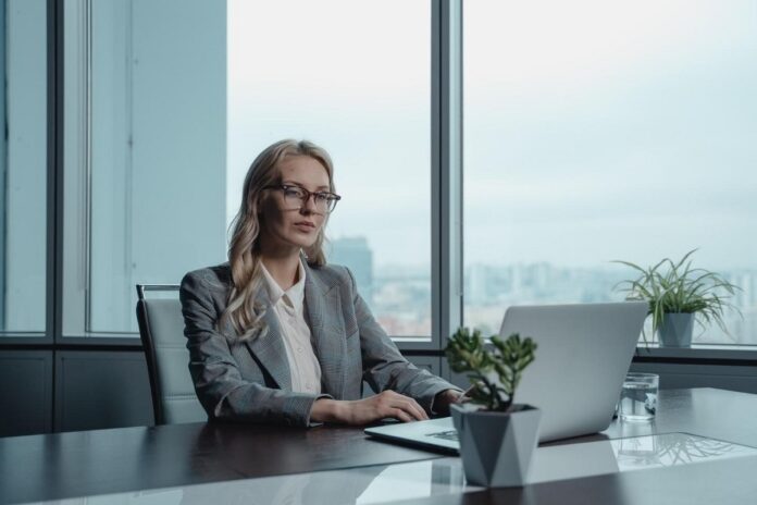 Sharply dressed real estate investor using her laptop to explore business opportunities